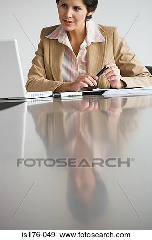 Businesswoman at her desk View Large Photo Image Stock Photo - Businesswoman at her desk. Fotosearch