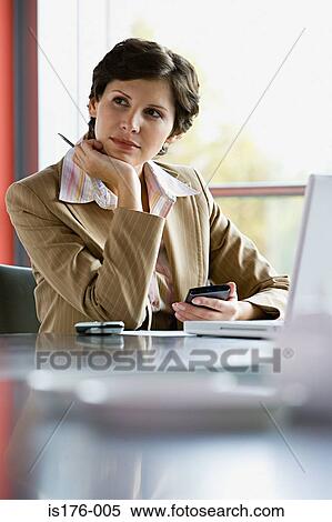 Stock Photography - Businesswoman at her desk. Fotosearch