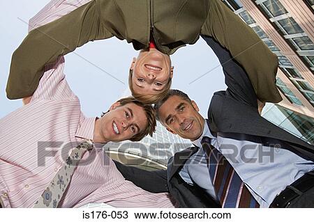 Colleagues in a huddle View Large Photo Image Stock Image - Colleagues in a huddle. Fotosearch