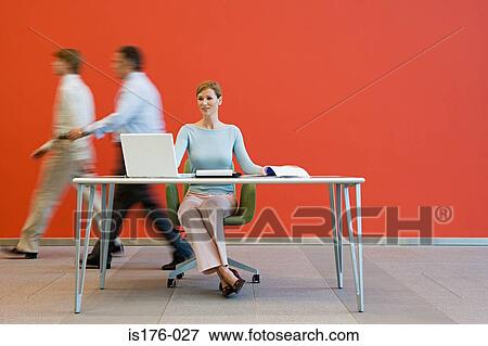 Men walking past woman at desk View Large Photo Image Stock Photo - Men walking past woman at desk. Fotosearch