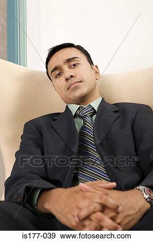 Businessman sitting in chair View Large Photo Image Stock Photo - Businessman sitting in chair. Fotosearch