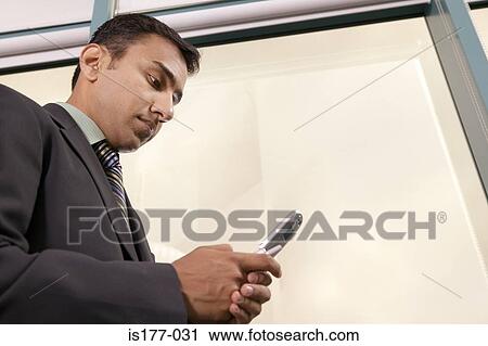 Businessman using cell phone View Large Photo Image Stock Image - Businessman using cell phone. Fotosearch