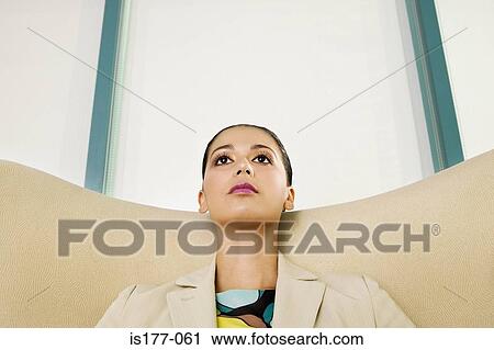 Stock Image - Businesswoman looking up. Fotosearch
