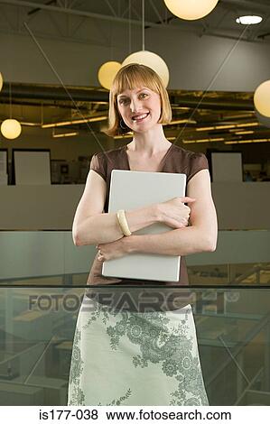 Woman clutching laptop computer View Large Photo Image Stock Photo - Woman clutching laptop computer. Fotosearch