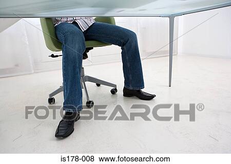 Stock Photo - Legs of man under desk. Fotosearch