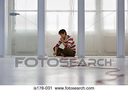 Man with laptop on floor View Large Photo Image Stock Image - Man with laptop on floor. Fotosearch