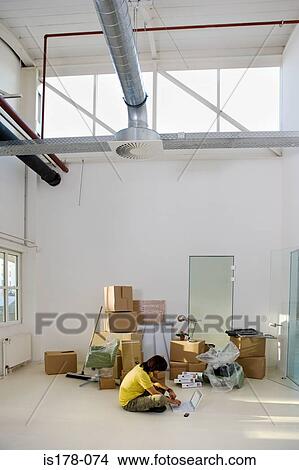 Man working in new office View Large Photo Image Picture - Man working in new office. Fotosearch