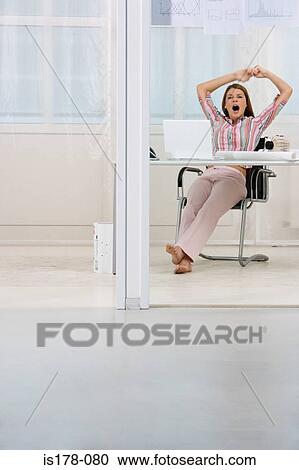 Office worker yawning and stretching View Large Photo Image Stock Image - Office worker yawning and stretching. Fotosearch