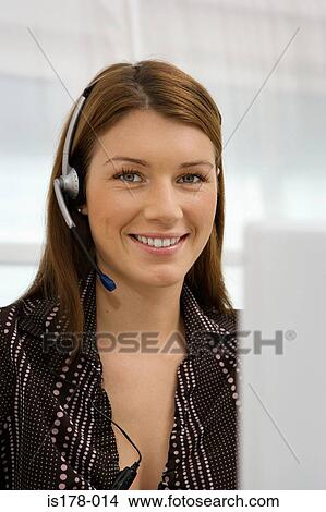 Picture - Woman wearing telephone headset. Fotosearch