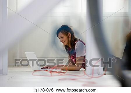 Woman with laptop on floor View Large Photo Image Stock Photograph - Woman with laptop on floor. Fotosearch