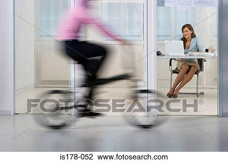 Woman working as man rides bike View Large Photo Image Stock Image - Woman working as man rides bike. Fotosearch