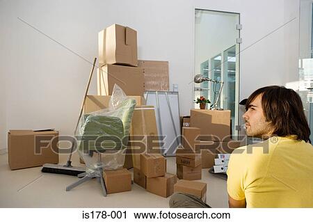 Young man in a new office View Large Photo Image Stock Image - Young man in a new office. Fotosearch