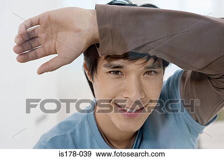 Stock Photo - Young man leaning on glass. Fotosearch