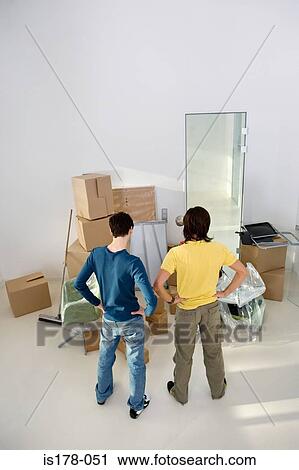Young men looking at cardboard boxes View Large Photo Image Stock Image - Young men looking at cardboard boxes. Fotosearch