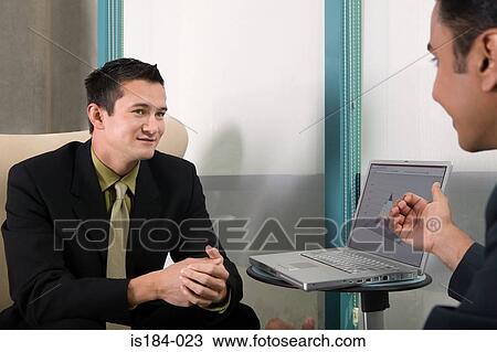 Businessmen having a discussion View Large Photo Image Stock Image - Businessmen having a discussion. Fotosearch