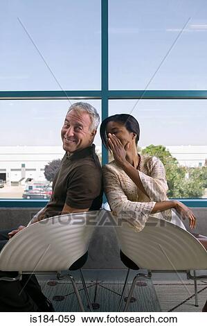 Colleagues gossiping View Large Photo Image Stock Photo - Colleagues gossiping. Fotosearch
