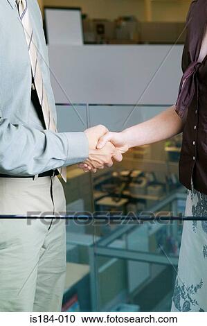 Stock Image - Colleagues shaking hands. Fotosearch