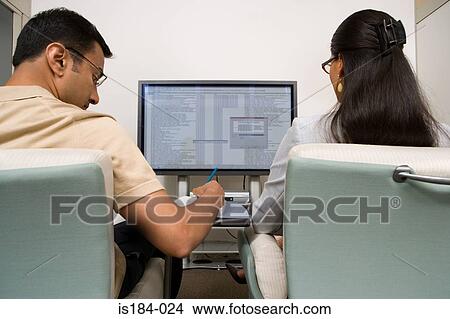Colleagues watching presentation View Large Photo Image Picture - Colleagues watching presentation. Fotosearch