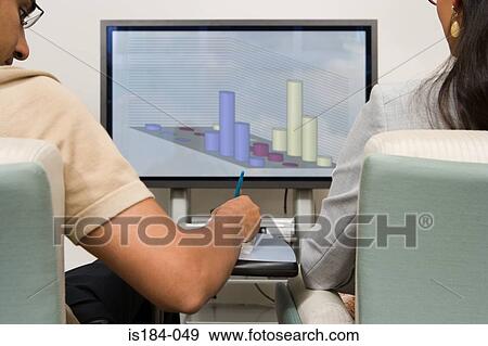 Colleagues watching presentation View Large Photo Image Stock Photo - Colleagues watching presentation. Fotosearch