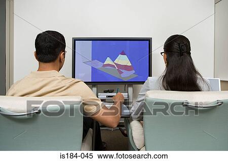 Colleagues watching presentation View Large Photo Image Stock Photography - Colleagues watching presentation. Fotosearch