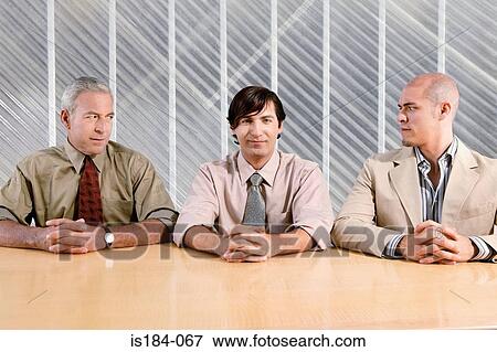 Man and suspicious colleagues View Large Photo Image Stock Photo - Man and suspicious colleagues. Fotosearch