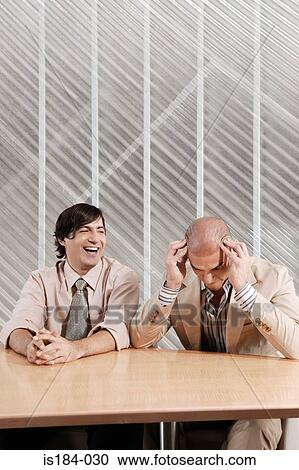 Man laughing at his colleague View Large Photo Image Stock Image - Man laughing at his colleague. Fotosearch
