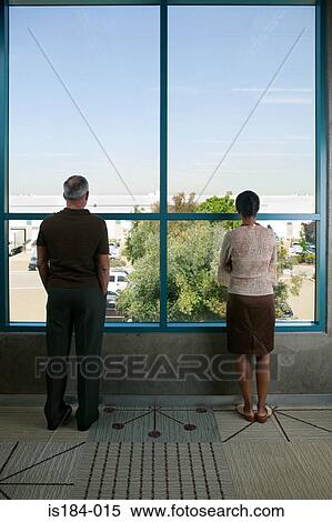 Office workers looking out of window View Large Photo Image Stock Photography - Office workers looking out of window. Fotosearch