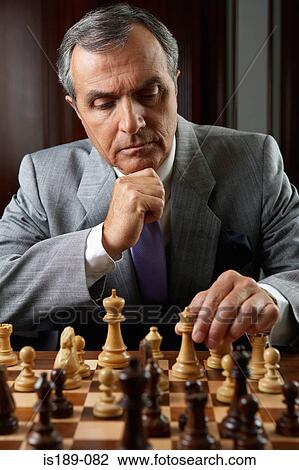 Stock Image - Ceo playing a game of chess. Fotosearch