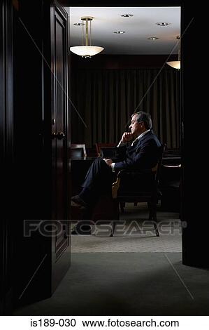 Stock Image - Portrait of a ceo in his office. Fotosearch