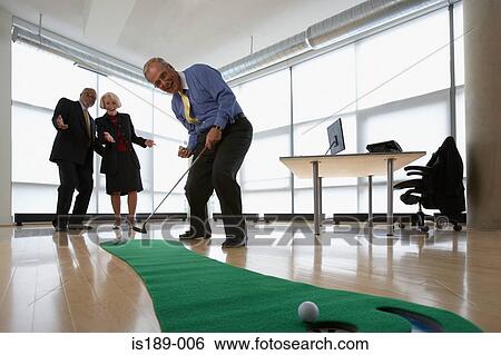 Stock Photograph - Three senior office workers practicing putting. Fotosearch