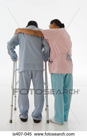 Nurse helping patient to walk View Large Photo Image Stock Photography - Nurse helping patient to walk. Fotosearch