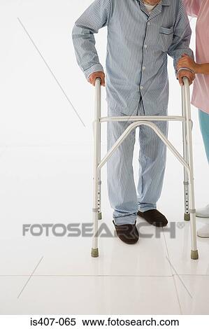 Nurse helping patient to walk View Large Photo Image Stock Photography - Nurse helping patient to walk. Fotosearch
