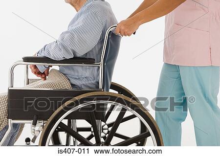 Nurse pushing man in wheelchair View Large Photo Image Stock Image - Nurse pushing man in wheelchair. Fotosearch