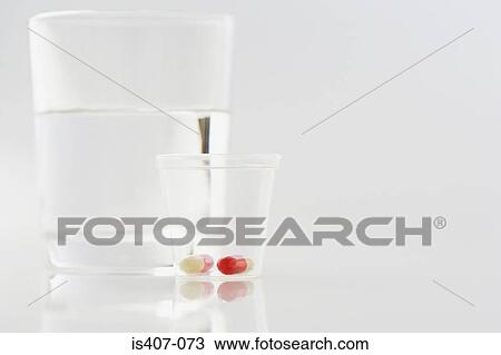 Pills with glass of water View Large Photo Image Stock Image - Pills with glass of water. Fotosearch
