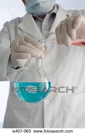 Scientist performing an experiment View Large Photo Image Stock Image - Scientist performing an experiment. Fotosearch