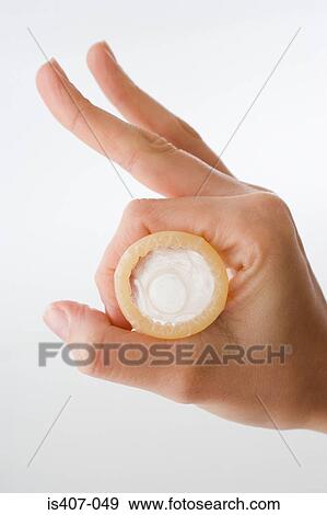 Woman holding a condom making ok sign View Large Photo Image Stock Photo - Woman holding a condom making ok sign. Fotosearch