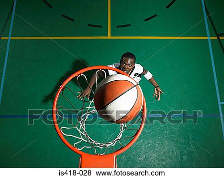 Stock Photo - Basketball player scoring. Fotosearch