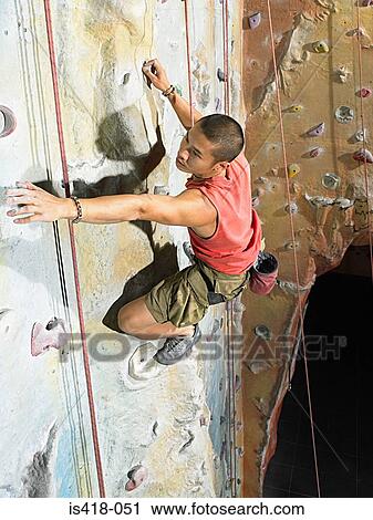 Man on climbing wall View Large Photo Image Stock Image - Man on climbing wall. Fotosearch