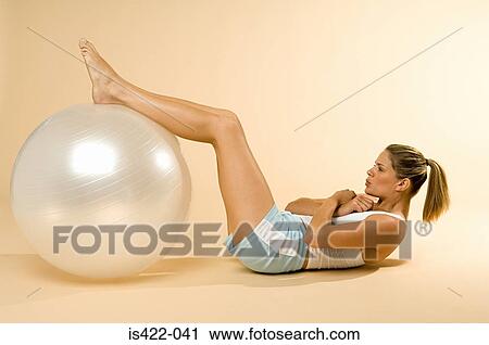 Woman doing sit-ups with exercise ball View Large Photo Image Stock Image - Woman doing sit-ups with exercise ball. Fotosearch