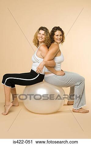 Women sitting on an exercise ball View Large Photo Image Stock Image - Women sitting on an exercise ball. Fotosearch
