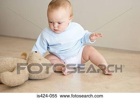 Baby reaching for a teddy bear View Large Photo Image Stock Photography - Baby reaching for a teddy bear. Fotosearch