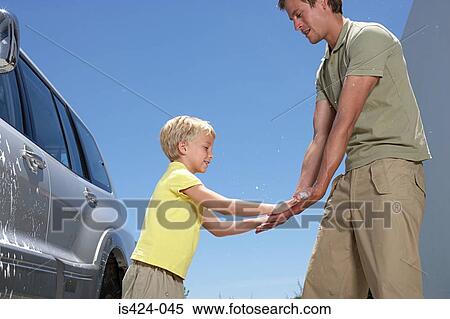 Boy giving father a high five View Large Photo Image Stock Photography - Boy giving father a high five. Fotosearch