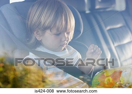 Child sitting in car View Large Photo Image Stock Photo - Child sitting in car. Fotosearch