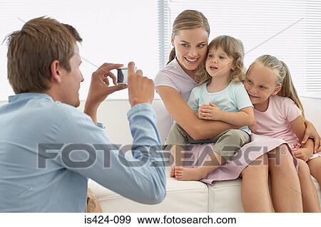 Family posing for a photograph View Large Photo Image Stock Photo - Family posing for a photograph. Fotosearch