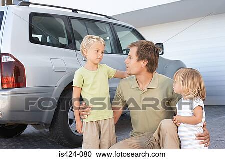 Stock Image - Father comforting his children. Fotosearch