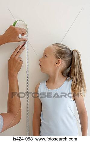 Measuring a childs height View Large Photo Image Stock Photo - Measuring a childs height. Fotosearch