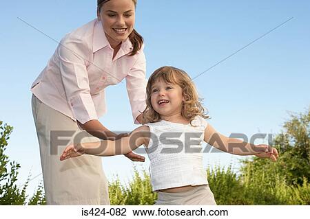 Mother and daughter playing in the garden View Large Photo Image Stock Image - Mother and daughter playing in the garden. Fotosearch