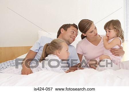 Mother and father comforting their daughter View Large Photo Image Stock Photo - Mother and father comforting their daughter. Fotosearch