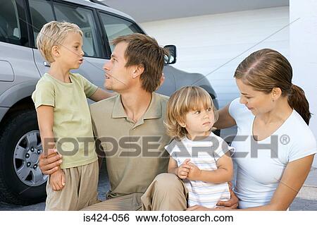 Mother and father comforting their children View Large Photo Image Stock Photograph - Mother and father comforting their children. Fotosearch