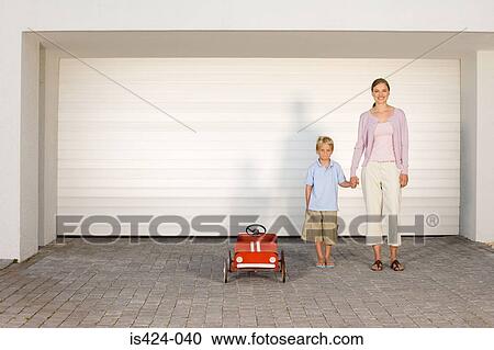 Mother and son stood by toy car View Large Photo Image Stock Image - Mother and son stood by toy car. Fotosearch